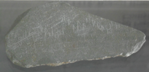 Slate fragment showing the earliest example of polyphonic music discovered in Scotland. 